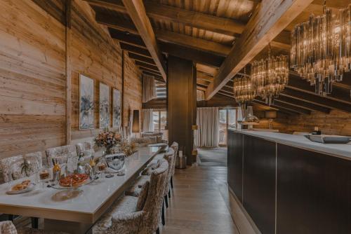 a dining room with a long table and chairs at Ultima Hotel Gstaad in Gstaad