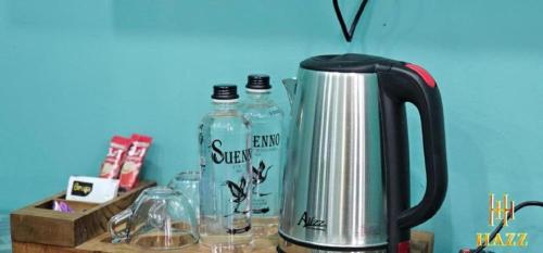 a tea kettle and two bottles of water on a counter at Haz Boutique Hotel Baku in Baku