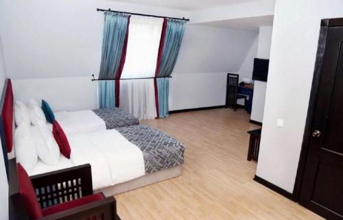 a bedroom with a bed and a television in it at Haz Boutique Hotel Baku in Baku