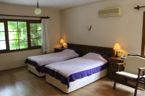Кровать или кровати в номере Nirvana Hotel