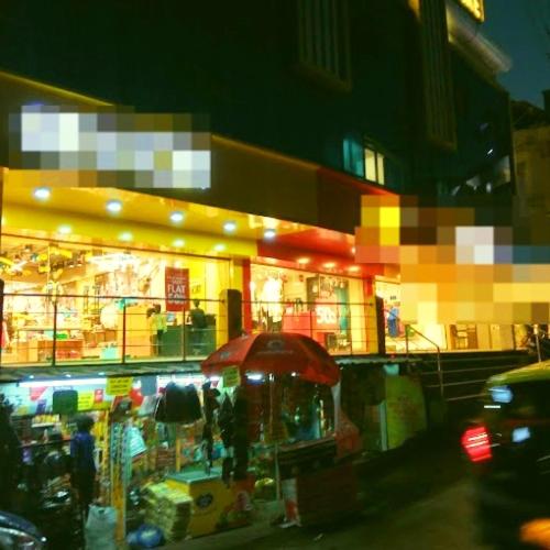 a store with an umbrella in front of it at Majestic Mano in Shillong