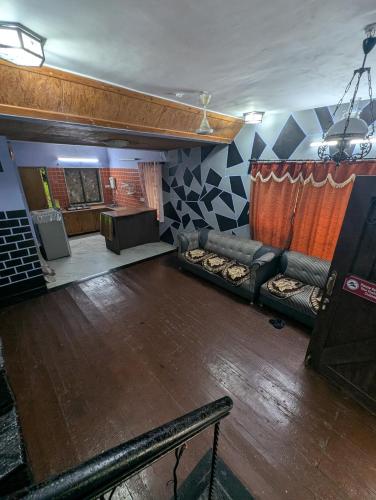 a living room with a couch and a stage at Hill View cottage in Khandala