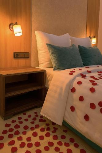 a bedroom with a bed with red hearts on it at Serenity apartments in Azrou