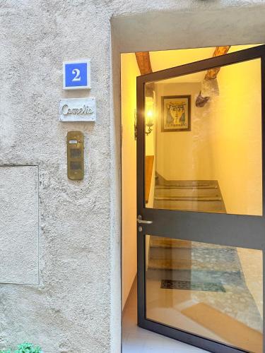 a door to a building with a sign that says at Gritti Palace Morcote - Camelia - Spacious historic house by the lake in Morcote