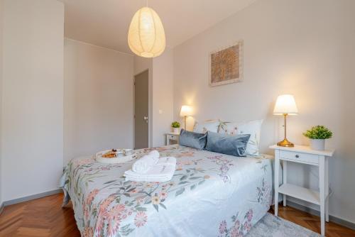 a bedroom with a bed with two shoes on it at HostWise - Bright & Spacious Flat w/ Garage in Porto