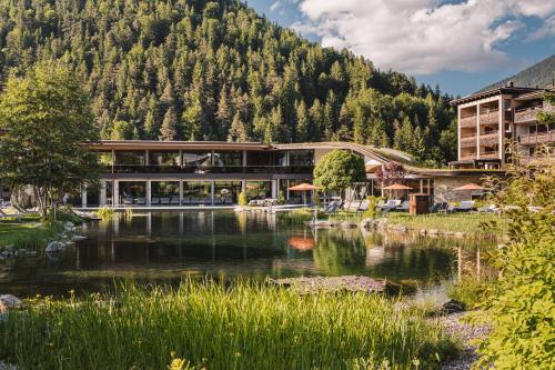 a resort with a lake in front of a mountain at Rieser Achensee Resort in Pertisau