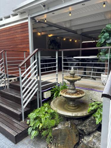 a fountain sitting on the side of a building at Atlantic Affair Boutique Hotel in Cape Town