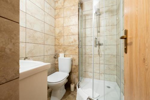 a bathroom with a toilet and a shower and a sink at Casa TT House in Sfântu-Gheorghe