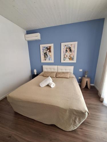 a bedroom with a large bed with two towels on it at Home Suites Home in Salionze