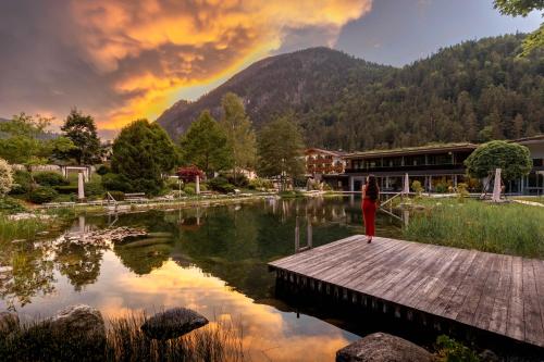 a woman standing on a dock near a lake at Rieser Achensee Resort in Pertisau