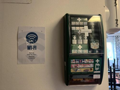 a vending machine on the side of a wall at Rentalux Hostel - Budget Double & Single rooms in Timrå