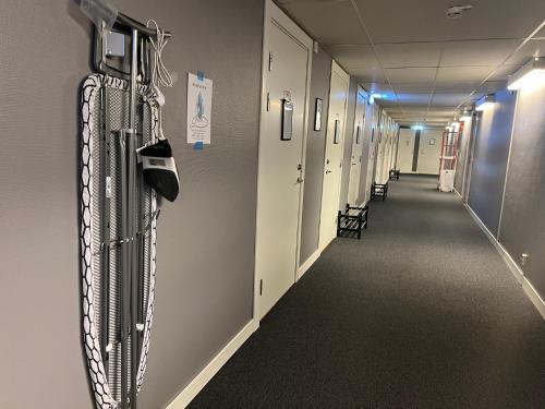 a corridor of a hospital hallway with chains and hooks at Rentalux Hostel - Budget Double & Single rooms in Timrå
