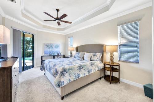 a bedroom with a bed and a ceiling fan at Active Luxury Living with Golf Amenities in Bonita Springs