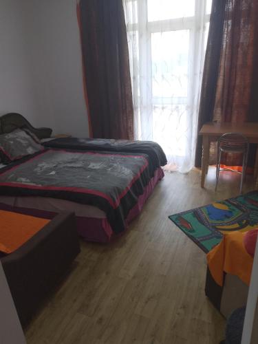 a bedroom with two beds and a window with curtains at Nea Iskra Vyletska Berezhanska street in Lviv