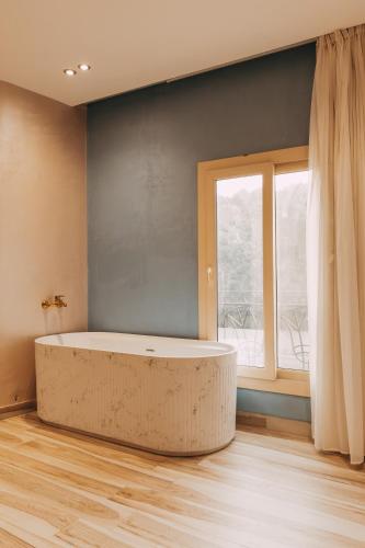 a large bath tub in a room with a window at Almas Pyramids Hotel in Cairo