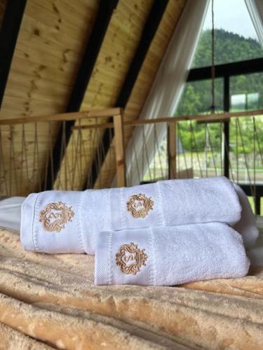 three white towels sitting on top of a table at Sunshine Borjomi in Borjomi