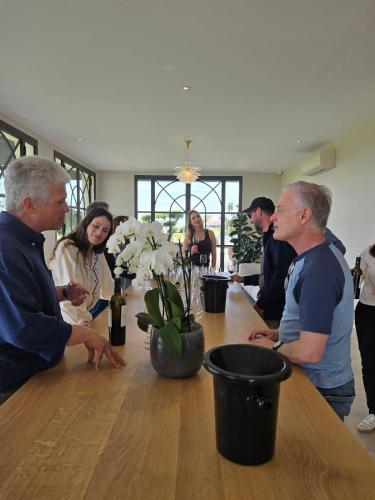 a group of people standing around a table with flowers at Château de Courtebotte in Saint-Jean-de-Blaignac