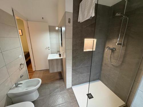 a bathroom with a shower and a toilet and a sink at Kalon Brion House in Lamezia Terme