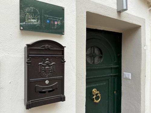 a door and a mailbox next to a green door at Kalon Brion House in Lamezia Terme