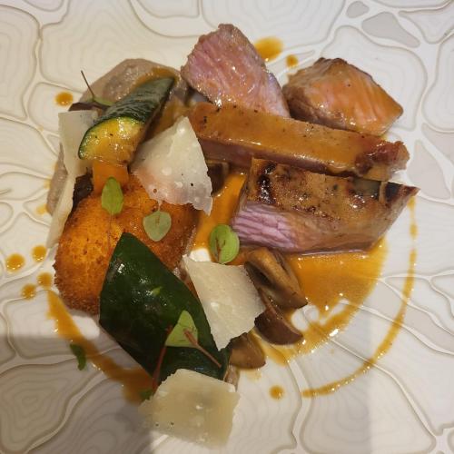 a plate of food with meat and vegetables on it at Château de Courtebotte in Saint-Jean-de-Blaignac