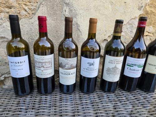 a group of wine bottles sitting on a table at Château de Courtebotte in Saint-Jean-de-Blaignac