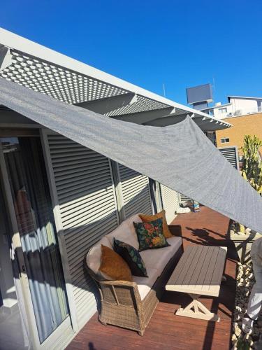 a patio with a couch on a deck at Atlantic Affair Boutique Hotel in Cape Town