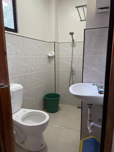 a bathroom with a toilet and a sink at Drop & Go Residence in San Juan