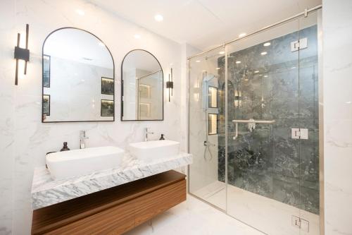 a bathroom with two sinks and a shower at Luxurious 3BR APT Offering Full Burj AlArab Views in Dubai