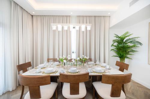 a dining room with a table and some chairs at Luxurious 3BR APT Offering Full Burj AlArab Views in Dubai