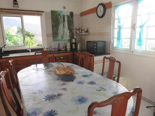 a kitchen with a table with a table cloth on it at Chambres Dhotes Nicole Maillot in Sainte-Marie