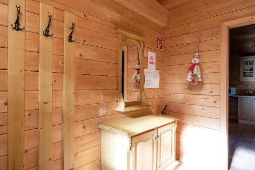 a log cabin with a bench in a room at Feriendorf Koralpe Chalet Alpenperle in Hartelsberg