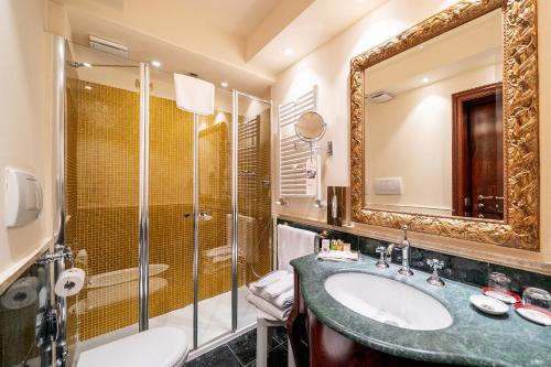 a bathroom with a sink and a shower at Hotel Locanda Remedio in Venice
