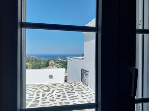 a view from a window looking out at the ocean at Perla Pool Hotel Andros in Ménites