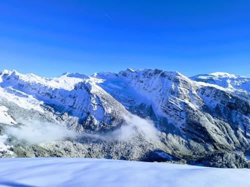 a view of a mountain range with snow at Chez Lucienne, jacuzzi et sauna in Samoëns
