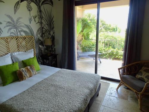 a bedroom with a bed and a sliding glass door at Maison du Lac in Les Angles Gard