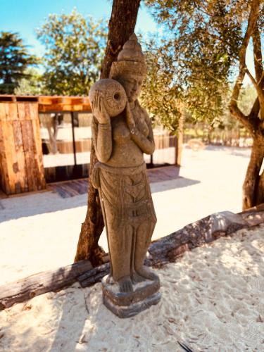 a statue of a child holding a stuffed animal at Domaine FINCA LESSYA, Lodge insolite & SPA in Mauguio