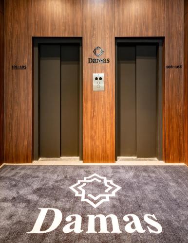 a row of elevators with the name ofdaindaindaindaindaindaindain at Damas Suites Budapest in Budapest