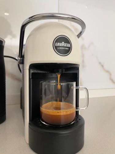 a food processor with a cup of coffee in it at Next door One & Only Portonovi in Kumbor