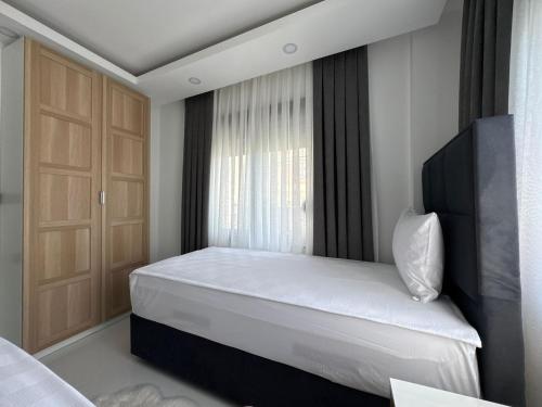 a bedroom with a bed and a window at Sweet Apartment in Side