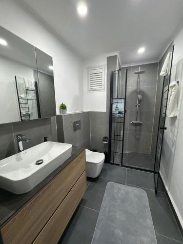 a bathroom with a sink and a shower and a toilet at Sweet Apartment in Side