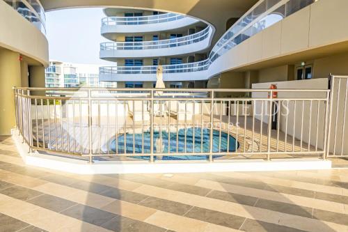a cage in the middle of a building with a pool at Bloomfields Stylish 2br in Ajwan Soul Beach Access in Abu Dhabi
