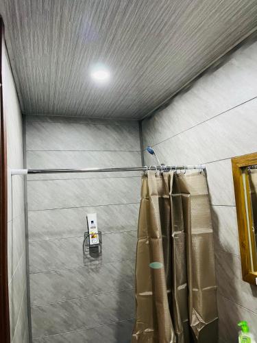 a room with a shower curtain in a garage at Vardzia Chachkari Cottage in Gogasheni