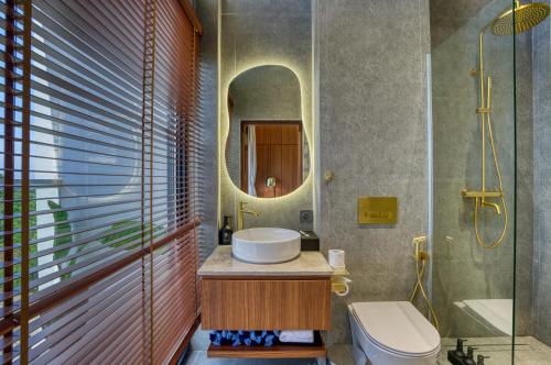 a bathroom with a sink and a mirror at U Villas II - Uluwatu in Uluwatu