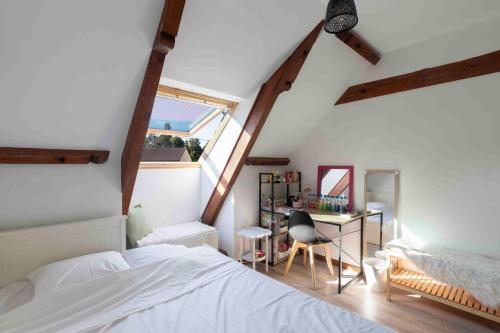 a bedroom with a bed and a desk and a window at Cabana & Pavillon Bressan - Garden, Parking in Pierre-de-Bresse