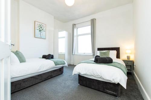 a bedroom with two beds and a window at K Suites - Granville Avenue in Long Eaton