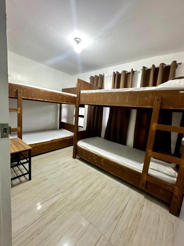 a room with three bunk beds in a room at Scarlett Rae Bungalow house with Lake View in Angeles