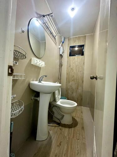 a bathroom with a sink and a toilet and a mirror at Scarlett Rae Bungalow house with Lake View in Angeles