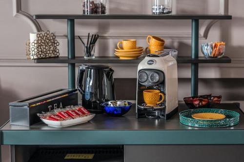a kitchen counter with a coffee maker on a table at Contrada 18 in Oderzo