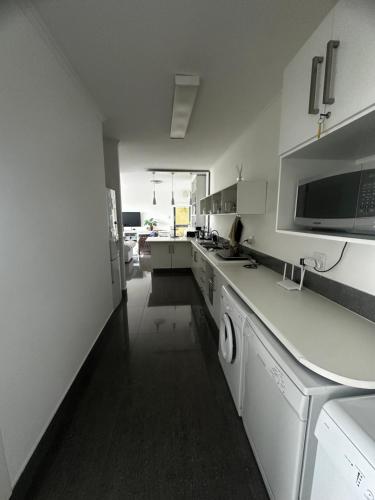 a kitchen with white appliances and a counter top at Tranquillo in Mossel Bay