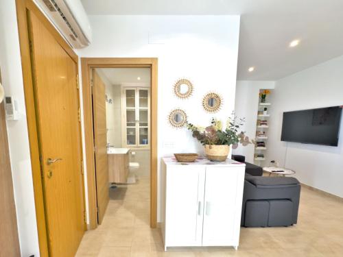 a living room with a couch and a television at Charming Apartment in the Heart of Old Town in Marbella